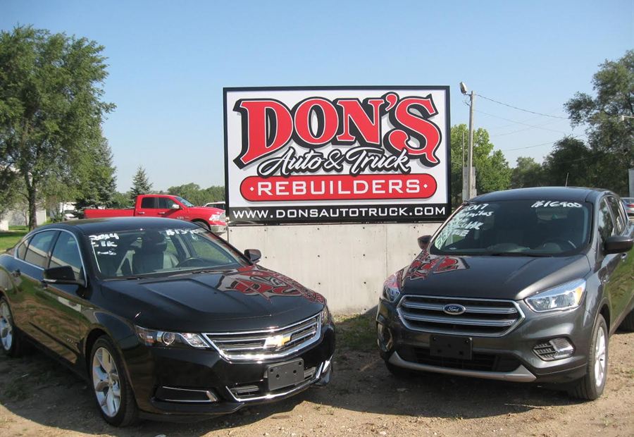 Dons Auto and Truck Rebuilders sign above vehicles at the Des Moines lot