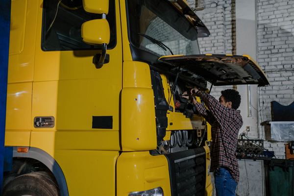 Heavy duty truck with the cab tilted open for parts removal